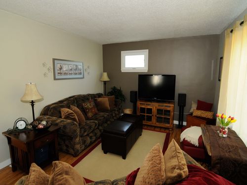 Living room has a full size couch, a love seat and a 50 inch flat screen TV.  Digital Cable