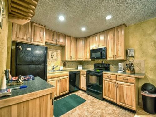 Fully Equipped Kitchen Open To Living and Dining Areas