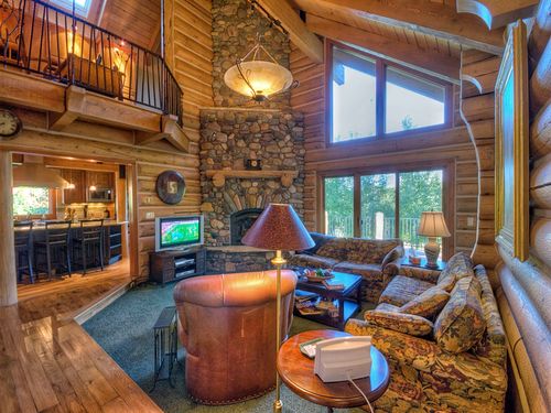 Main Living Area with Beautiful Riverstone Mantel and Flat Screen TV