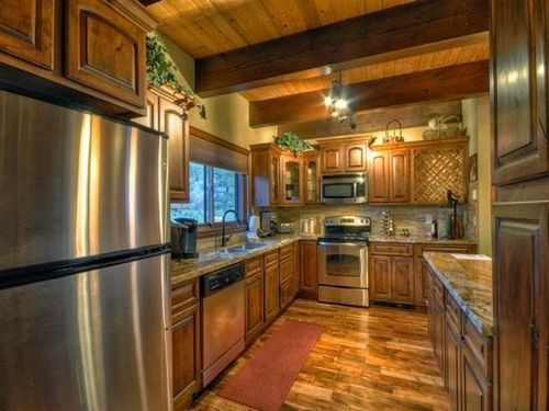 Fully Equipped Kitchen With Stainless Steel Appliances and Granite Countertops