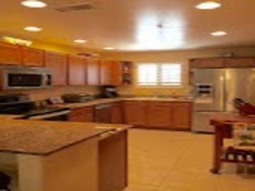 Kitchen with stainless steel appliances, granite counters & butcher block table