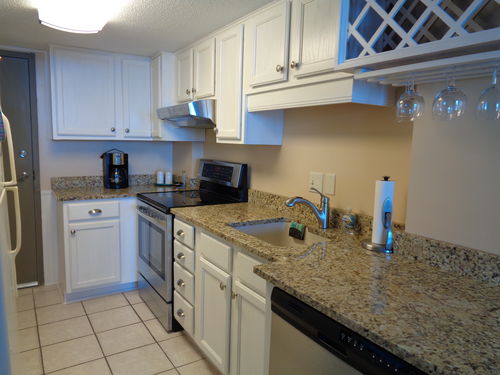Other side of kitchen with new electric stove, & dishwasher