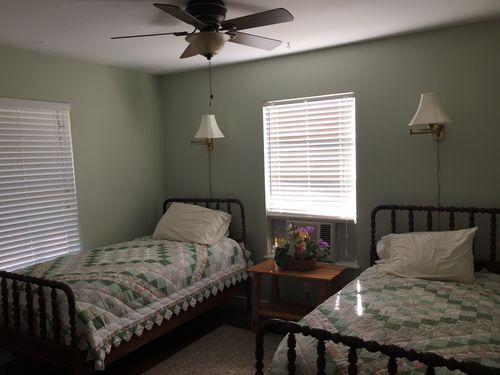 Guest bedroom with antique spool twin beds