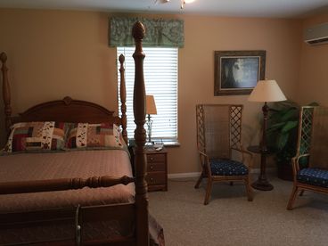 Master bedroom with queen 4 poster bed and quiet sitting area for reading or private conversation