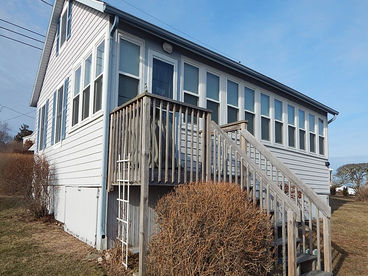 waterfront side of cottage with sunroom