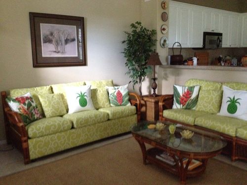 Spacious Living Room with two full size sofas, two chairs and a flat screen TV.