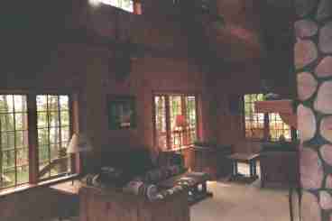 Cathedral ceiling with pine walls.  Rustic decor. Field stone fireplace.