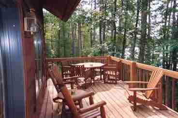 Lookout over the lake and wilderness frontage on full cedar deck complete with rustic furniture.