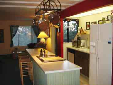 Kitchen with everything you could want including a new 25 cu ft refer, microwave, wet bar and new gas grill on the deck