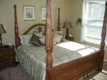 A 4 poster king size bed graces this ground floor master suite. 

Walk in shower, garden tub and his and hers vanities are in the large en-suite bathroom.

Patio doors lead to the pool area.
