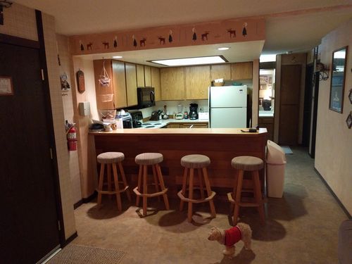 Fully equipped kitchen; 2 micro wave ovens, coffee maker, blender, crock pot, toaster, ice maker, oven, stove, and dishwasher; bar seating for four