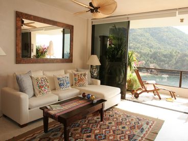 Over 20 feet of floor-to-ceiling glass separates the spacious living room from the live-on balcony