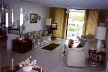 Roomy living-dining room with balcony overlooking pool.  Cable TV with 100 channels