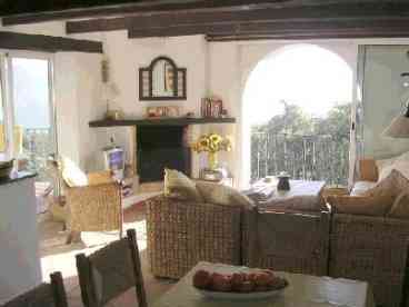 Comfortable Livingroom with Fireplace and Picture Windows onto Magnificant View.