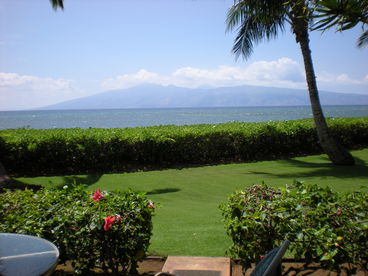 View from our condo lanai, beach just other side of low hedge.