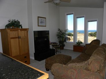 Enjoy the views , the fireplace, or a movie in this comfortable living/dining area