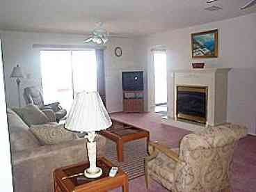 Spacious living room with gas fireplace.