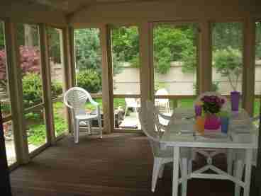 Screened porch leading to landscaped patio/yard