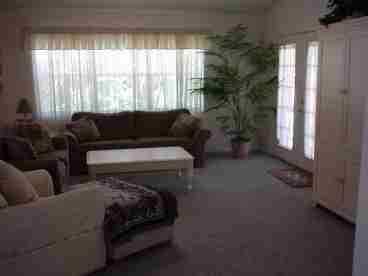 Living room includes plenty of seating and t.v. with basic cable and dvd player. Opens through french doors to private back yard.