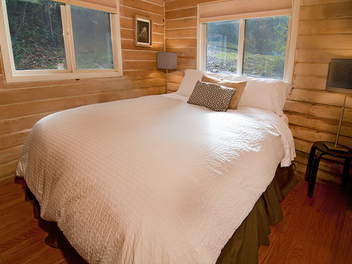 Master bedroom has queen size bed, while a second bedroom can be found in the detached guest cottage.