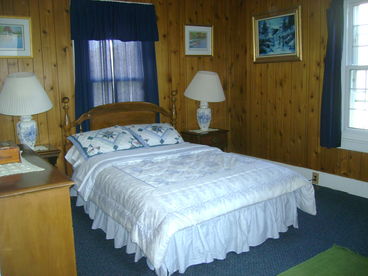 Come home from a day on the slopes to this lovely pine paneled bedroom at the Coach House apartment 101.