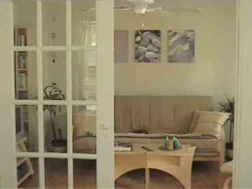 French doors lead from the living room into the bedroom.