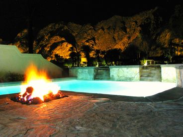 Night time view from the patio of those beautiful night-lit Santa Rosa Mountains.  Private pool, large spa, natural stone patio, firepit, BBQ, and plenty of seating complete the ambience.  Relax and enjoy that view while sitting in your private spa.  Nothing else in the Desert compares to the night time view here!  