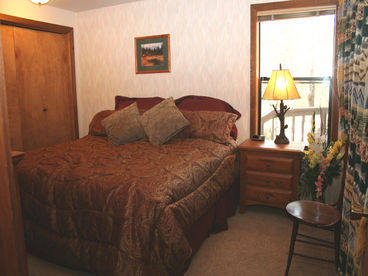 King bed with Tempurpedic mattress in downstairs bedroom.