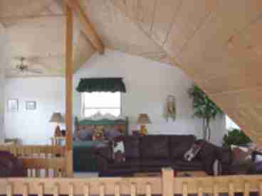 Large loft area with queen size bed, bath and sitting/TV area.