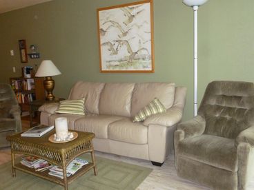 Two recliners and a comfy leather sleeper sofa--great for relaxing, napping, or enjoying the beach right outside.  Cool \