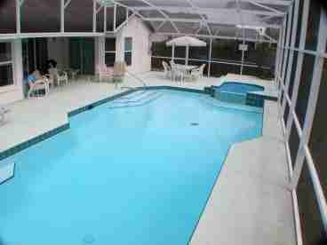 Oversized pool w covered lanai. Many extra pool chairs and loungers