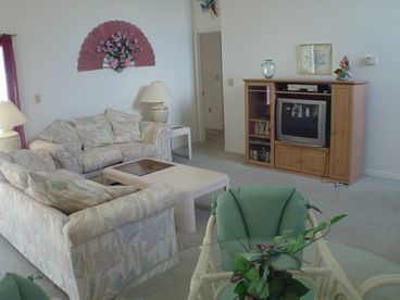 Living room showing entertainment centre and dining area