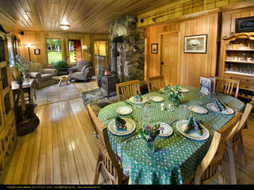 Main floor dining and living room with comfy chairs