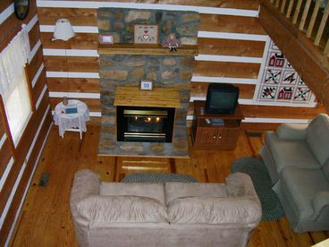 View of the Living Room from upstairs.  A great place to relax, enjoy the fireplace, watch TV or just visit.