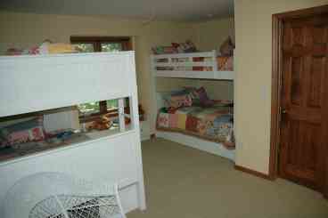 Upstairs bunkroom sleeps eight in two full-over-full bunkbeds.  Bunkroom and Upstairs Queen bedroom share a bathroom with tub/shower, double sinks and toilet.