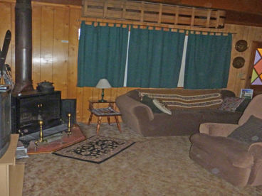 Wood burning stove/fireplace, sofa, recliner, desk, 2 chairs., TV, heater, games, activity & restaurant binders. Free wifi
