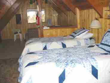 2 twin beds, trundle bed,  card table & chairs, TV w/ cable. room on floor for sleeping bags, extra blankets & pillows, deck off sliding doors.