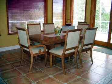Dining Area. Large table with wall of windows. Bright and cheerful. (Not shown: guests can view the TV from the dining room.) Easy access to large balcony.