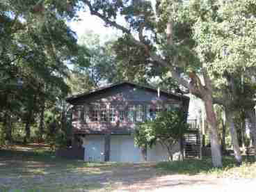 The Lodge windows look down on a refreshing, sparkling lake. This was taken from the dock, where you can feed the fish (or hook 'em) or just dangle yer toes in the water. The property is nestled in the arms of many beautiful oaks and pines... the feel of the real old Florida!