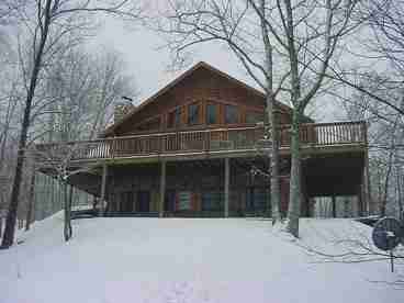 VIEW OF THE BACK OF THE CABIN IN THE WINTER SEASON.