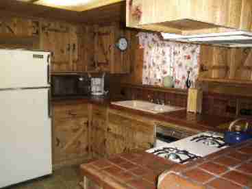 Full kitchen with all utensils, dishes, pots and pans.