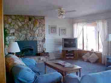 Cozy Living Room with gas fireplace and large windows facing the Pacific.