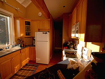 Gourmet Kitchen with stove, refridgerator, microwave and many other appliances.