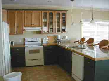 The large open kitchen features smooth top range, dishwasher, refrig with icemaker, disposal and many small appliances.  There is an open counter that seats 4 and a diningoom table that seats 6.  There are sliding doors that open to a covered deck so you can enjoy watching the dophins swim by while having your morning coffee.  