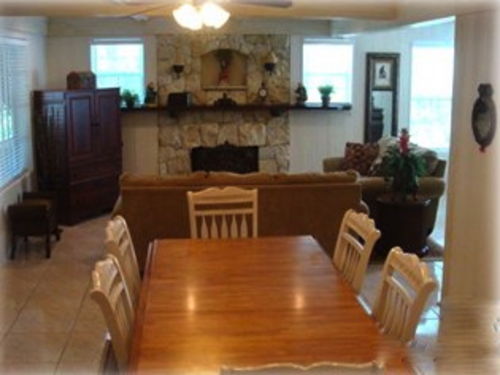 Beautiful dining, living room and sun room areas! Lush landscaping surround the beach house.