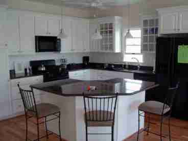 Gourmet Kitchen with Center Island, Granite Countertops and Upgraded Appliances