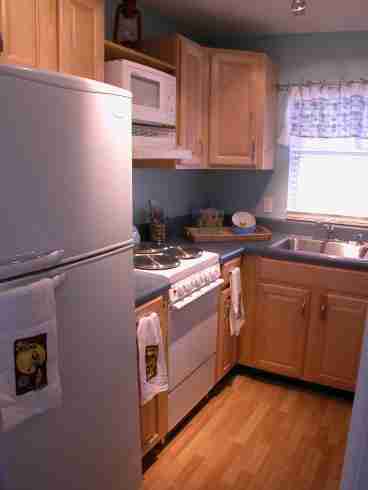 This beautiful functional kitchen was completely remodeled this summer with new cabinets and counter top and hardwood floors.