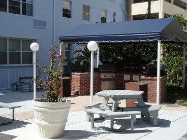 Garden BBQ Area with 6 grills and plenty of picnic tables with shade.