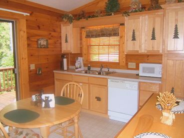Spacious eat-in kitchen w/dishwasher, microwave, toaster oven, stove and pots & pans/coffee maker and filters. Breakfast bar/overlooks greatroom.