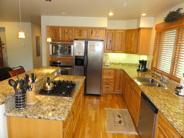 Full kitchen with all appliances, granite counters, and center island with gas cook top